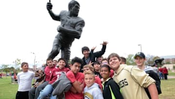 NORMAN, OK - SEPTEMBER 19: The Woodward, Oklahoma eighth-grade football team poses on the statue of Oklahoma Heisman recipient Steve Owens before the game against the Tulsa Golden Hurricane September 19, 2015 at Gaylord Family-Oklahoma Memorial Stadium in Norman, Oklahoma. Oklahoma defeated Tulsa 52-38.(Photo by Brett Deering/Getty Images)