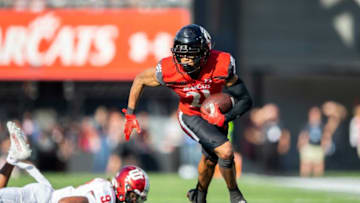 Cincinnati Bearcats wide receiver Tyler Scott runs for a touchdown against the Indiana Hoosiers. The Enquirer.