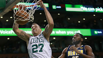 BOSTON - DECEMBER 13: Boston Celtics' Daniel Theis scores two second quarter points over Denver's Kenneth Faried. The Boston Celtics host the Denver Nuggets in a regular season NBA basketball game at TD Garden in Boston on Dec. 13, 2017. (Photo by Jim Davis/The Boston Globe via Getty Images)