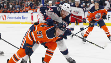 Dec 16, 2021; Edmonton, Alberta, CAN; Columbus Blue Jackets defensemen Vladislav Gavrikov (44) pulls down Edmonton Oilers forward Connor McDavid (97) during the third period at Rogers Place. Mandatory Credit: Perry Nelson-USA TODAY Sports