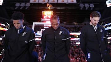 Oct 29, 2016; San Antonio, TX, USA; San Antonio Spurs forward Kawhi Leonard (middle) during the national anthem before a game against the New Orleans Pelicans at AT&T Center. Mandatory Credit: Soobum Im-USA TODAY Sports