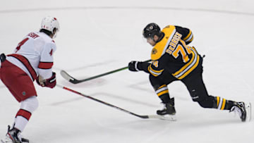 Aug 19, 2020; Toronto, Ontario, CAN; Boston Bruins left wing Jake DeBrusk (74) shoots against Carolina Hurricanes defenseman Haydn Fleury (4) during the first period in game five of the first round of the 2020 Stanley Cup Playoffs at Scotiabank Arena. Mandatory Credit: John E. Sokolowski-USA TODAY Sports