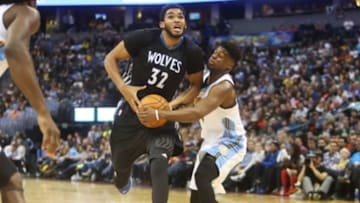 Oct 30, 2015; Denver, CO, USA; Denver Nuggets guard Emmanuel Mudiay (0) strips the ball away from Minnesota Timberwolves center Karl-Anthony Towns (32) during the first half at Pepsi Center. Mandatory Credit: Chris Humphreys-USA TODAY Sports