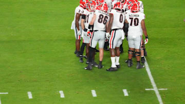 Georgia Bulldogs huddle during the game against the Michigan Wolverines during the first half in the Capital One Orange Bowl for the College Football Playoff semifinal game at Hard Rock Stadium on December 31, 2021 in Miami Gardens, Florida. (Photo by Mark Brown/Getty Images)