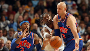 DENVER - JANUARY 08: Zydrunas Ilgauskas #11 of the Cleveland Cavaliers dishes off the ball to Mo Williams #2 as Nene #31 of the Denver Nuggets defends during NBA action at Pepsi Center on January 8, 2010 in Denver, Colorado. The Nuggets defeated the Cavaliers 99-97. NOTE TO USER: User expressly acknowledges and agrees that, by downloading and/or using this Photograph, user is consenting to the terms and conditions of the Getty Images License Agreement. (Photo by Doug Pensinger/Getty Images)