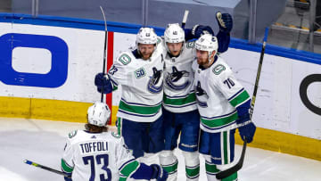 EDMONTON, ALBERTA - AUGUST 25: Elias Pettersson #40 of the Vancouver Canucks is congratulated by his teammates, Alexander Edler #23, Tyler Toffoli #73 and Tanner Pearson #70 after scoring a goal against the Vegas Golden Knights during the second period in Game Two of the Western Conference Second Round during the 2020 NHL Stanley Cup Playoffs at Rogers Place on August 25, 2020 in Edmonton, Alberta, Canada. (Photo by Bruce Bennett/Getty Images)