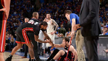 PHILADELPHIA, PA - APRIL 14: James Johnson #16 of the Miami Heat helps Goran Dragic #7 of the Miami Heat off the floor during the game against the Philadelphia 76ers (Photo by David Dow/NBAE via Getty Images)