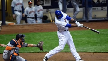 Apr 8, 2016; Milwaukee, WI, USA; Milwaukee Brewers first baseman Chris Carter (33) hits a 2-run homer in the first inning as Houston Astros catcher Jason Castro (15) watches at Miller Park. Mandatory Credit: Benny Sieu-USA TODAY Sports