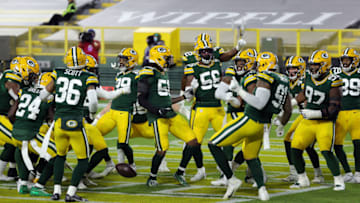 GREEN BAY, WISCONSIN - NOVEMBER 29: Players dance and surround Preston Smith #91 of the Green Bay Packers in the end zone after Smith recovered a fumble and ran it back for a touchdown during the 1st half of the game against the Chicago Bears at Lambeau Field on November 29, 2020 in Green Bay, Wisconsin. (Photo by Stacy Revere/Getty Images)
