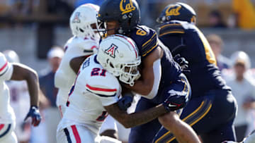 Sep 24, 2022; Berkeley, California, USA; Arizona Wildcats safety Jaxen Turner (21) hits California Golden Bears running back Jaydn Ott (6) during the second quarter at FTX Field at California Memorial Stadium. Mandatory Credit: Darren Yamashita-USA TODAY Sports