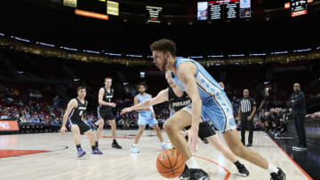 Nov 24, 2022; Portland, Oregon, USA; North Carolina Tar Heels forward Pete Nance (32) drives to the basket during the second half against Portland Pilots guard Tyler Robertson (2) at Moda Center. North Carolina won the game 89-81. Mandatory Credit: Troy Wayrynen-USA TODAY Sports