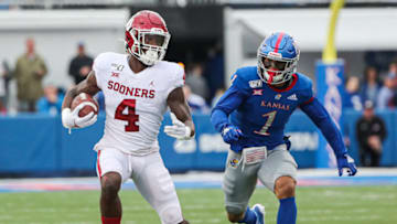Oct 5, 2019; Lawrence, KS, USA; Oklahoma Sooners running back Trey Sermon (4) runs against Kansas Jayhawks safety Bryce Torneden (1) during the first half at David Booth Kansas Memorial Stadium. Mandatory Credit: Jay Biggerstaff-USA TODAY Sports