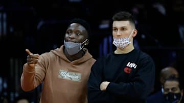 PHILADELPHIA, PENNSYLVANIA - DECEMBER 15: Victor Oladipo #4 (L) and Tyler Herro #14 of the Miami Heat look on during the first quarter against the Philadelphia 76ers at Wells Fargo Center on December 15, 2021 in Philadelphia, Pennsylvania. NOTE TO USER: User expressly acknowledges and agrees that, by downloading and or using this photograph, User is consenting to the terms and conditions of the Getty Images License Agreement. (Photo by Tim Nwachukwu/Getty Images)