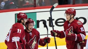 Sep 22, 2014; Glendale, AZ, USA; Arizona Coyotes center Martin Hanzal (11) celebrates with center Max Domi (16) and center Henrik Samuelsson (15) after scoring a goal in the second period against the Los Angeles Kings at Gila River Arena. Mandatory Credit: Matt Kartozian-USA TODAY Sports