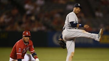 Aug 17, 2016; Anaheim, CA, USA; Seattle Mariners second baseman Robinson Cano (22) watches his throw after forcing out Los Angeles Angels shortstop Andrelton Simmons (left) during the third inning at Angel Stadium of Anaheim. Mandatory Credit: Kelvin Kuo-USA TODAY Sports