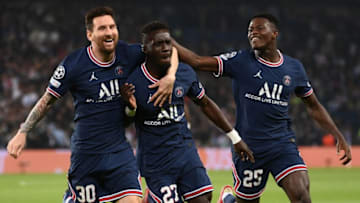 TOPSHOT - Paris Saint-Germain's Senegalese midfielder Idrissa Gana Gueye (C) celebrates with Paris Saint-Germain's Argentinian forward Lionel Messi (L) and Paris Saint-Germain's Portuguese defender Nuno Mendes after scoring a goal during the UEFA Champions League first round group A football match between Paris Saint-Germain's (PSG) and Manchester City, at The Parc des Princes, in Paris, on September 28, 2021. (Photo by FRANCK FIFE / AFP) (Photo by FRANCK FIFE/AFP via Getty Images)
