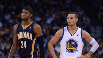 January 20, 2014; Oakland, CA, USA; Indiana Pacers small forward Paul George (24) and Golden State Warriors point guard Stephen Curry (30) during the third quarter at Oracle Arena. The Pacers defeated the Warriors 102-94. Mandatory Credit: Kyle Terada-USA TODAY Sports