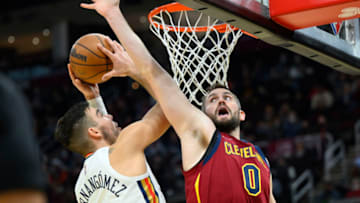 Jan 31, 2022; Cleveland, Ohio, USA; Cleveland Cavaliers forward Kevin Love (0) defends New Orleans Pelicans center Willy Hernangomez (9) in the third quarter at Rocket Mortgage FieldHouse. Mandatory Credit: David Richard-USA TODAY Sports