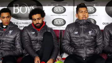 BURNLEY, ENGLAND - DECEMBER 05: Trent Alexander-Arnold of Liverpool, Mohamed Salah of Liverpool and Roberto Firmino of Liverpool looks on from the bench during the Premier League match between Burnley FC and Liverpool FC at Turf Moor on December 5, 2018 in Burnley, United Kingdom. (Photo by Alex Livesey/Getty Images)