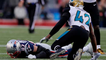FOXBOROUGH, MA - JANUARY 21: Rob Gronkowski #87 of the New England Patriots reacts after an injury after being hit by Barry Church #42 of the Jacksonville Jaguars in the second quarter during the AFC Championship Game at Gillette Stadium on January 21, 2018 in Foxborough, Massachusetts. (Photo by Kevin C. Cox/Getty Images)