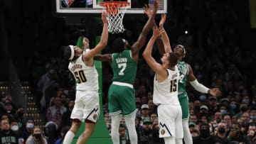 Feb 11, 2022; Boston, Massachusetts, USA; Boston Celtics guard Jaylen Brown (7) and center Robert Williams III (44) go for a rebound over Denver Nuggets center Nikola Jokic (15) during the second half at TD Garden. Mandatory Credit: Winslow Townson-USA TODAY Sports