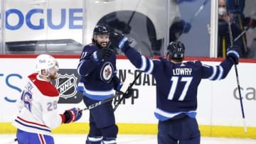Feb 25, 2021; Winnipeg, Manitoba, CAN; Winnipeg Jets center Nate Thompson (11) celebrates his third period goal with Winnipeg Jets left wing Adam Lowry (17) against the Montreal Canadiens at Bell MTS Place. Mandatory Credit: James Carey Lauder-USA TODAY Sports