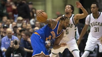 Oct 28, 2015; Milwaukee, WI, USA; New York Knicks forward Derrick Williams (23) drives for the basket as Milwaukee Bucks guard Michael Carter-Williams (5) defends during the first quarter at BMO Harris Bradley Center. Mandatory Credit: Jeff Hanisch-USA TODAY Sports