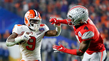 GLENDALE, ARIZONA - DECEMBER 28: Travis Etienne #9 of the Clemson Tigers runs the ball against Jordan Fuller #4 of the Ohio State Buckeyes during the College Football Playoff Semifinal at the PlayStation Fiesta Bowl at State Farm Stadium on December 28, 2019 in Glendale, Arizona. (Photo by Ralph Freso/Getty Images)