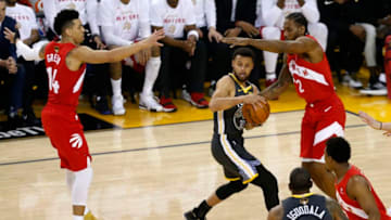 OAKLAND, CALIFORNIA - JUNE 07: Stephen Curry #30 of the Golden State Warriors is defended by Danny Green #14 and Kawhi Leonard #2 of the Toronto Raptors in the first half during Game Four of the 2019 NBA Finals at ORACLE Arena on June 07, 2019 in Oakland, California. NOTE TO USER: User expressly acknowledges and agrees that, by downloading and or using this photograph, User is consenting to the terms and conditions of the Getty Images License Agreement. (Photo by Lachlan Cunningham/Getty Images)