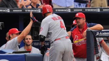 Jul 26, 2013; Atlanta, GA, USA; St. Louis Cardinals catcher Yadier Molina (4) shakes hands at his dugout after hitting a home run against the Atlanta Braves during the second inning at Turner Field. Mandatory Credit: Dale Zanine-USA TODAY Sports