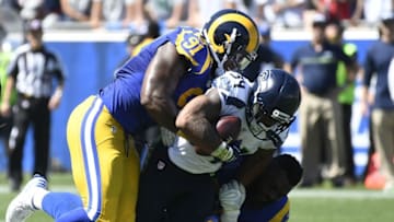 Sep 18, 2016; Los Angeles, CA, USA; Seattle Seahawks running back Thomas Rawls (34) is tackled by Los Angeles Rams defensive tackle Dominique Easley (91) during the first half of a NFL game at Los Angeles Memorial Coliseum. Mandatory Credit: Richard Mackson-USA TODAY Sports