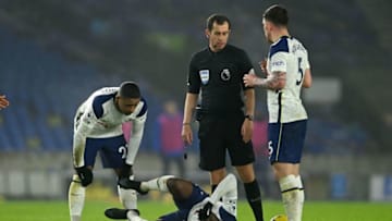 Tottenham Hotspur's French midfielder Tanguy Ndombele (C) reacts after being hurt during the English Premier League football match between Brighton and Tottenham Hotspur at the American Express Community Stadium in Brighton, southern England on January 31, 2021. (Photo by MIKE HEWITT/POOL/AFP via Getty Images)
