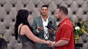 LAS VEGAS, NEVADA - SEPTEMBER 01: Ryan Reaves (C) of the Vegas Golden Knights performs a renewal of vows for Laura Long (L) and Justin Long during a ceremony at Chapel of the Flowers on September 1, 2019 in Las Vegas, Nevada. The Long's ceremony was the result of the couple winning a social media contest sponsored by the chapel. (Photo by David Becker/Getty Images)
