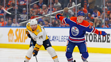 Nov 4, 2023; Edmonton, Alberta, CAN; Nashville Predators forward Gustav Nyquist (14) and Edmonton Oilers forward Ryan Nugent-Hopkins (93) look for a loose puck during the third period at Rogers Place. Mandatory Credit: Perry Nelson-USA TODAY Sports