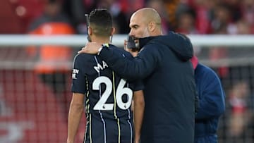 Manchester City's Spanish manager Pep Guardiola talks with Manchester City's Algerian midfielder Riyad Mahrez as they leave the pitch following the English Premier League football match between Liverpool and Manchester City at Anfield in Liverpool, north west England on October 7, 2018. - The match ended in a draw 0-0. (Photo by Paul ELLIS / AFP) / RESTRICTED TO EDITORIAL USE. No use with unauthorized audio, video, data, fixture lists, club/league logos or 'live' services. Online in-match use limited to 120 images. An additional 40 images may be used in extra time. No video emulation. Social media in-match use limited to 120 images. An additional 40 images may be used in extra time. No use in betting publications, games or single club/league/player publications. / (Photo credit should read PAUL ELLIS/AFP/Getty Images)