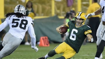 Aug 18, 2016; Green Bay, WI, USA; Green Bay Packers quarterback Joe Callahan (6) slides for a first down against Oakland Raiders linebacker Neiron Ball (58) in the third quarter at Lambeau Field. Mandatory Credit: Benny Sieu-USA TODAY Sports