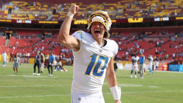 LANDOVER, MARYLAND - SEPTEMBER 12: Justin Herbert #10 of the Los Angeles Chargers celebrates after defeating the Washington Football Team 20-16 at FedExField on September 12, 2021 in Landover, Maryland. (Photo by Rob Carr/Getty Images)