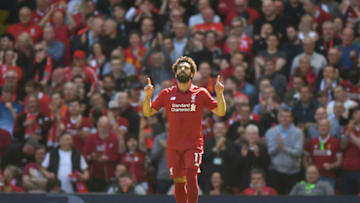 Liverpool's Egyptian midfielder Mohamed Salah celebrates after scoring during the English Premier League football match between Liverpool and Brighton and Hove Albion at Anfield in Liverpool, north west England on May 13, 2018. (Photo by Paul ELLIS / AFP) / RESTRICTED TO EDITORIAL USE. No use with unauthorized audio, video, data, fixture lists, club/league logos or 'live' services. Online in-match use limited to 75 images, no video emulation. No use in betting, games or single club/league/player publications. / (Photo credit should read PAUL ELLIS/AFP/Getty Images)