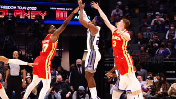 Jan 5, 2022; Sacramento, California, USA; Sacramento Kings guard Buddy Hield (24) shoots the ball between Atlanta Hawks forward-center Onyeka Okongwu (17) and guard Kevin Huerter (3) during the first quarter at Golden 1 Center. Mandatory Credit: Kelley L Cox-USA TODAY Sports