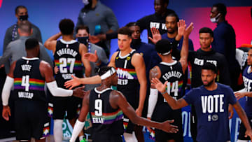 LAKE BUENA VISTA, FLORIDA - SEPTEMBER 22: Jerami Grant #9 of the Denver Nuggets and Paul Millsap #4 of the Denver Nuggets celebrate their win with teammates against the Los Angeles Lakers in Game Three of the Western Conference Finals during the 2020 NBA Playoffs at AdventHealth Arena at the ESPN Wide World Of Sports Complex on September 22, 2020 in Lake Buena Vista, Florida. NOTE TO USER: User expressly acknowledges and agrees that, by downloading and or using this photograph, User is consenting to the terms and conditions of the Getty Images License Agreement. (Photo by Mike Ehrmann/Getty Images)