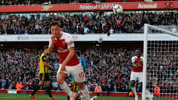 Arsenal's German midfielder Mesut Ozil (L) celebrates scoring their second goal during the English Premier League football match between Arsenal and Watford at the Emirates Stadium in London on September 29, 2018. (Photo by Adrian DENNIS / AFP) / RESTRICTED TO EDITORIAL USE. No use with unauthorized audio, video, data, fixture lists, club/league logos or 'live' services. Online in-match use limited to 120 images. An additional 40 images may be used in extra time. No video emulation. Social media in-match use limited to 120 images. An additional 40 images may be used in extra time. No use in betting publications, games or single club/league/player publications. / (Photo credit should read ADRIAN DENNIS/AFP/Getty Images)