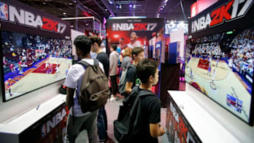 PARIS, FRANCE - OCTOBER 28: Gamers play the video game 'NBA 2K 17' developed by Visual Concepts and published 2K Sports on Sony PlayStation game consoles PS4 during the 'Paris Games Week' on October 28, 2016 in Paris, France. 'Paris Games Week' is an international trade fair for video games to be held from October 27 to October 31, 2016. (Photo by Chesnot/Getty Images)