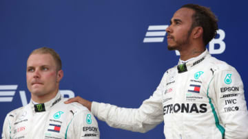 SOCHI, RUSSIA - SEPTEMBER 30: Race winner Lewis Hamilton of Great Britain and Mercedes GP and second placed Valtteri Bottas of Finland and Mercedes GP look on, on the podium during the Formula One Grand Prix of Russia at Sochi Autodrom on September 30, 2018 in Sochi, Russia. (Photo by Charles Coates/Getty Images)