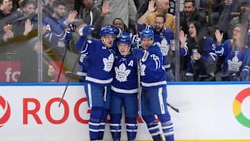 Nov 6, 2023; Toronto, Ontario, CAN; Toronto Maple Leafs forward Auston Matthews (left) and defenseman TJ Brodie (right) celebrate a goal by Toronto Maple Leafs forward Mitchell Marner (center) during the third period against the Tampa Bay Lightning at Scotiabank Arena. Mandatory Credit: John E. Sokolowski-USA TODAY Sports