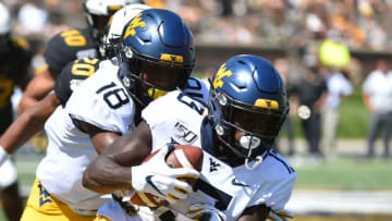 COLUMBIA, MISSOURI - SEPTEMBER 07: Wide receiver Sam James #13 of the West Virginia Mountaineers is tackled by defensive back Adam Sparks #14 of the Missouri Tigers in the fourth quarter at Faurot Field/Memorial Stadium on September 07, 2019 in Columbia, Missouri. (Photo by Ed Zurga/Getty Images)