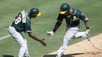 Sep 18, 2016; Arlington, TX, USA; Oakland Athletics left fielder Khris Davis (2) celebrates his homer with third base coach Ron Washington (38) against the Texas Rangers during the fourth inning of a baseball game at Globe Life Park in Arlington. Mandatory Credit: Jim Cowsert-USA TODAY Sports