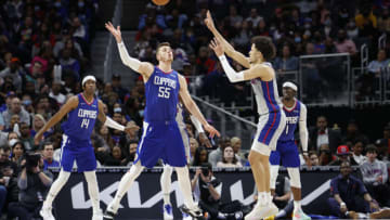 Mar 13, 2022; Detroit, Michigan, USA; Detroit Pistons guard Cade Cunningham (2) passes over LA Clippers center Isaiah Hartenstein (55) in the second half at Little Caesars Arena. Mandatory Credit: Rick Osentoski-USA TODAY Sports