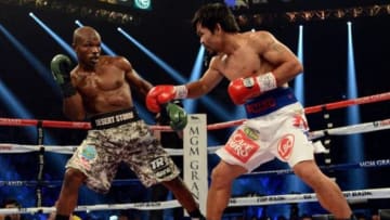 Apr 12, 2014; Las Vegas, NV, USA; Timothy Bradley Jr.(brown gloves) and Manny Pacquiao (red gloves) during their WBO World Welterweight Championship fight at MGM Grand Garden Arena. Mandatory Credit: Jayne Kamin-Oncea-USA TODAY Sports