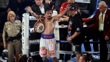 Apr 12, 2014; Las Vegas, NV, USA; Manny Pacquiao celebrates after defeating Tomothy Bradley Jr. (not pictured in their WBO World Welterweight Title bout at MGM Grand Garden Arena. Pacquiao won via unanimous decision. Mandatory Credit: Joe Camporeale-USA TODAY Sports