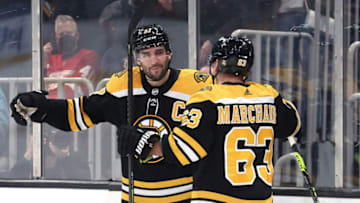 BOSTON, MASSACHUSETTS - NOVEMBER 04: Patrice Bergeron #37 of the Boston Bruins celebrates with Brad Marchand #63 after scoring a goal against the Detroit Red Wings during the third period at TD Garden on November 04, 2021 in Boston, Massachusetts. (Photo by Maddie Meyer/Getty Images)
